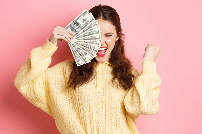 excited-beautiful-girl-saying-yes-earn-prize-money-holding-dollar-bills-half-face-making-fist