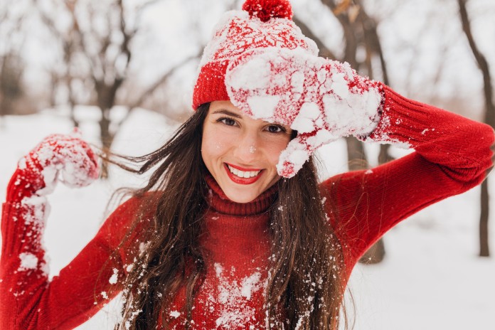 young-pretty-smiling-happy-woman-red-mittens-hat-wearing-knitted-sweater-walking-park-snow-warm-clothes-having-fun-waving-long-hair